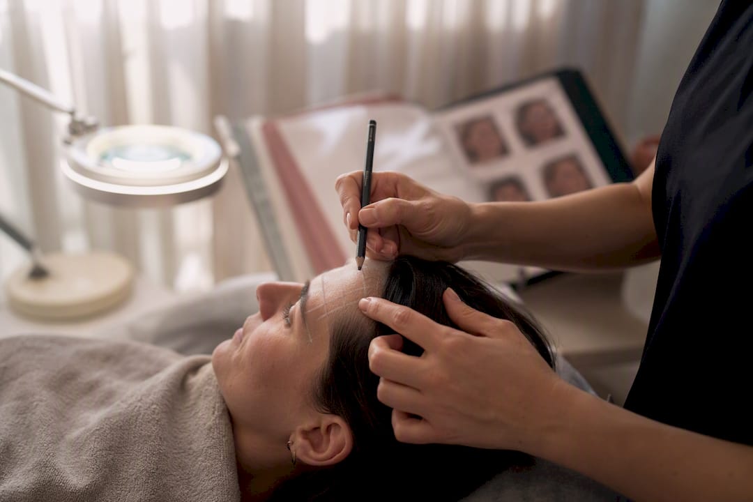 Clinician marking patient's face skin assessment