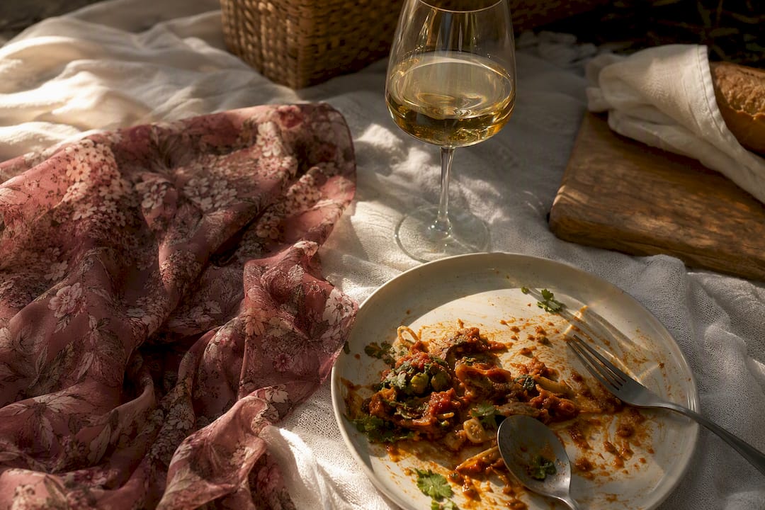 Spicy meal, red wine and sun hat as rosacea triggers