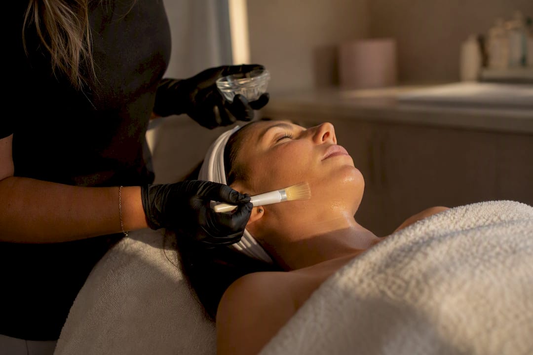 Clinician applying facial peel treatment
