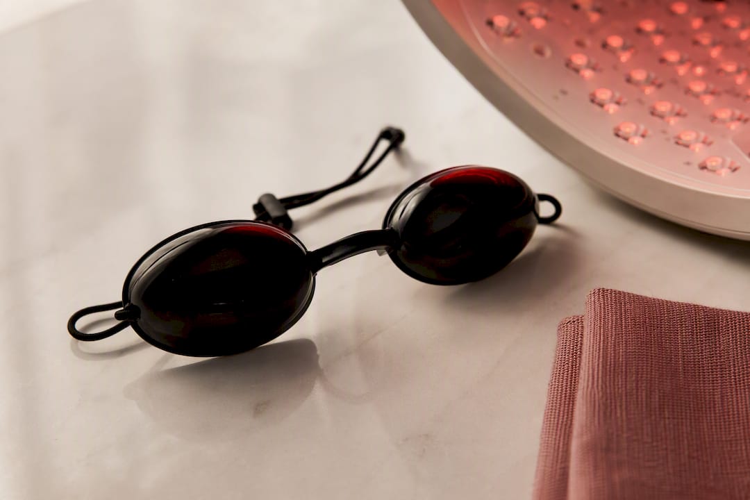 Protective goggles beside cropped therapy light