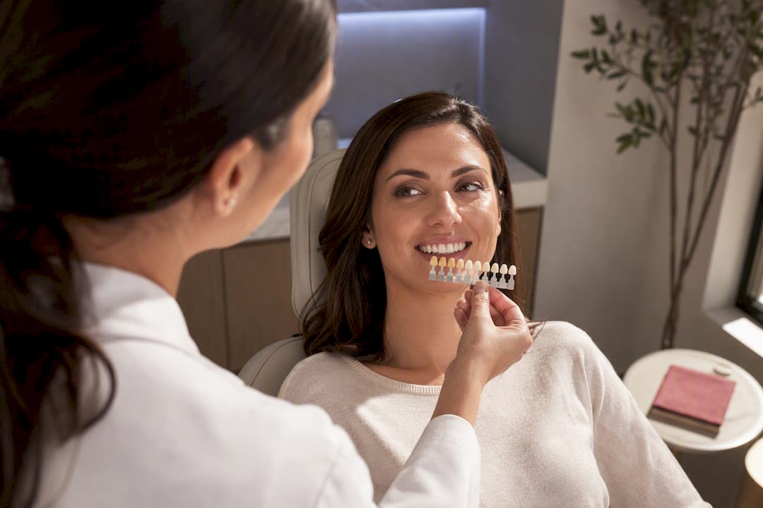 Clinician comparing tooth shade tabs