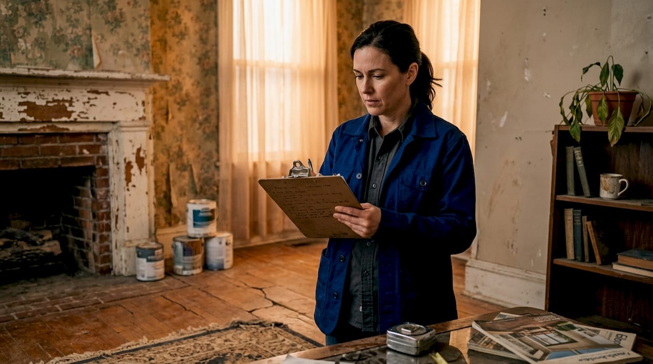 Contractor inspecting outdated living room interior