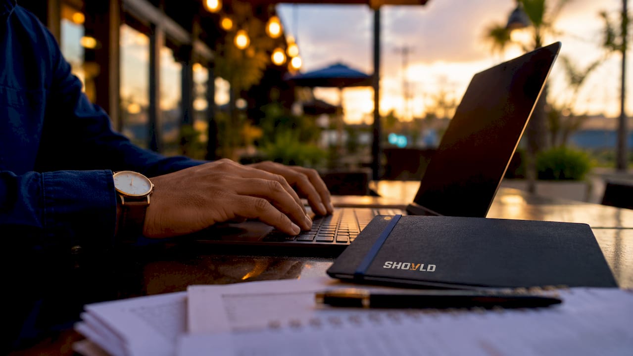 Hands typing permit data analysis