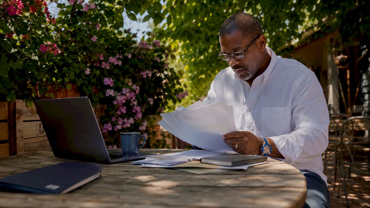 Investor examining tax lien documents at desk