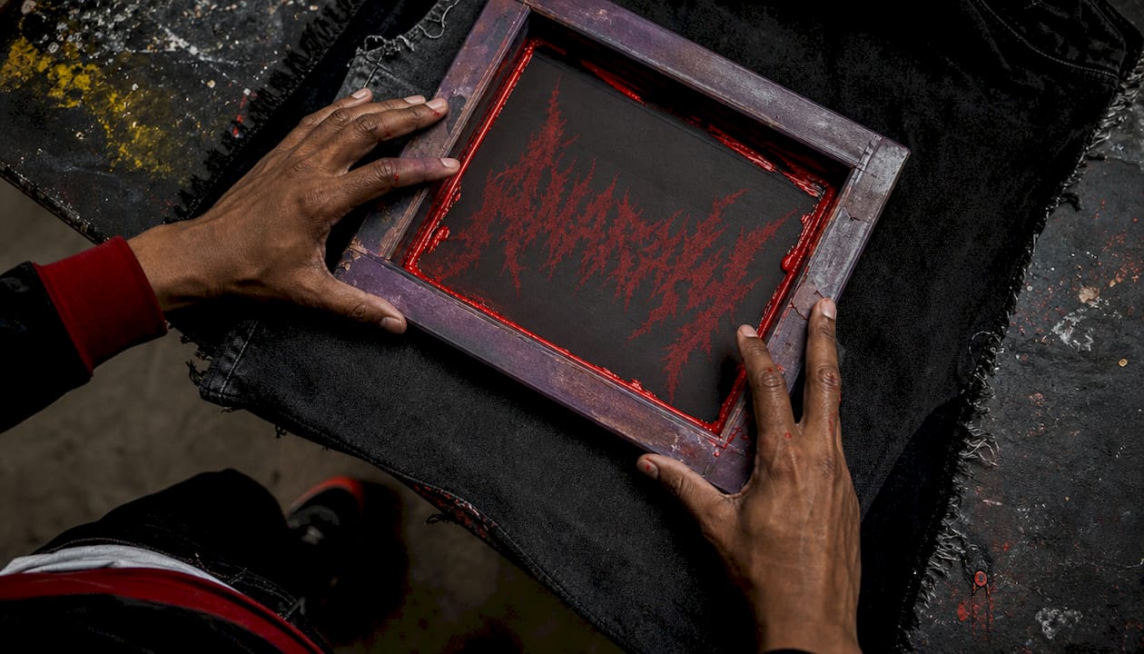 Hands screen printing typography on fabric