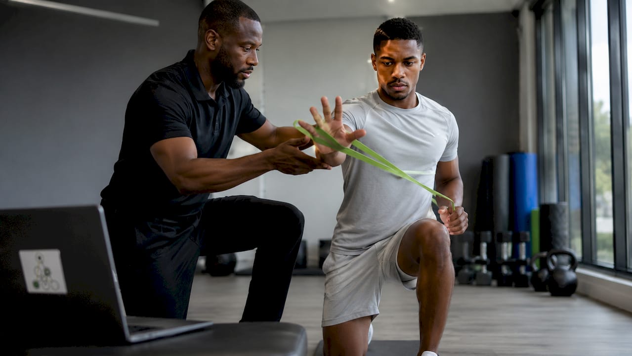 Therapist assisting athlete with motor skill exercises