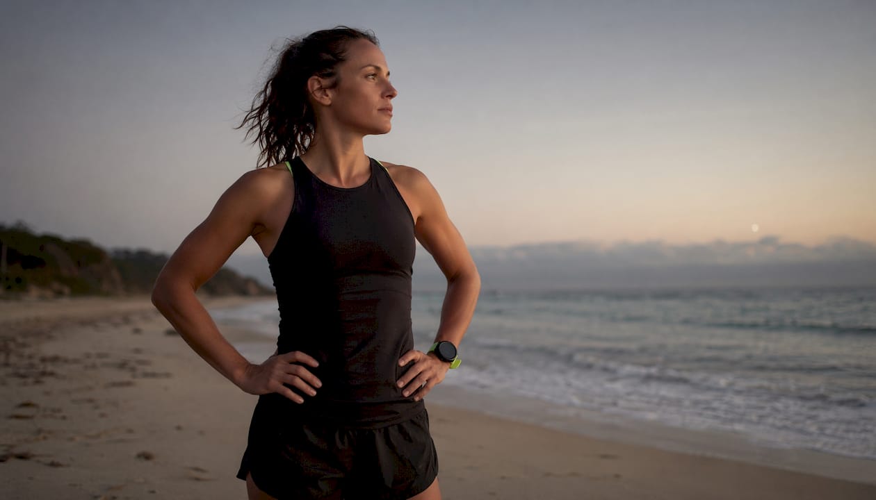 Runner reflecting on physical symptoms outdoors