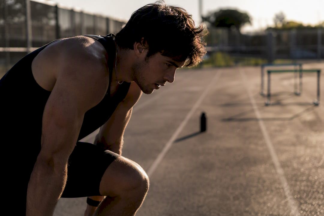 Athlete hesitating with muscle tension indoors