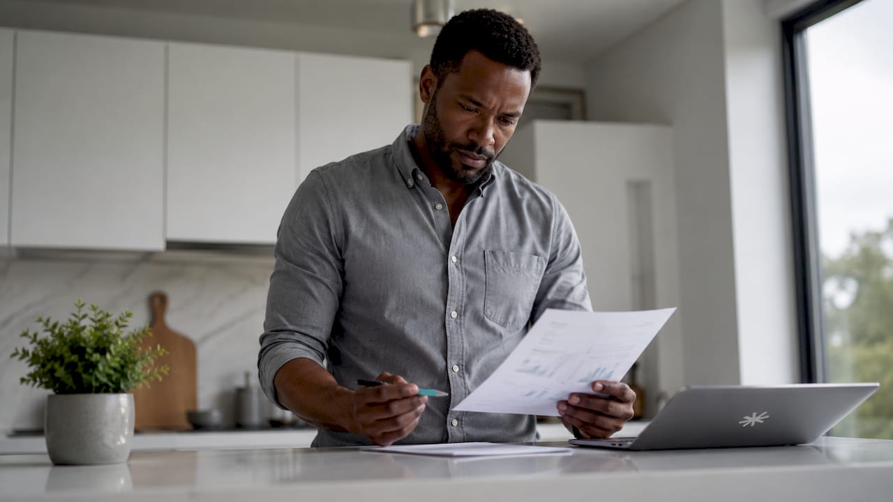 Man reviewing career assessment at home desk
