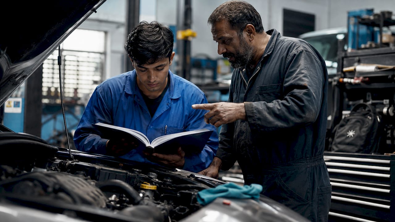 Apprentice learning trade skills in garage