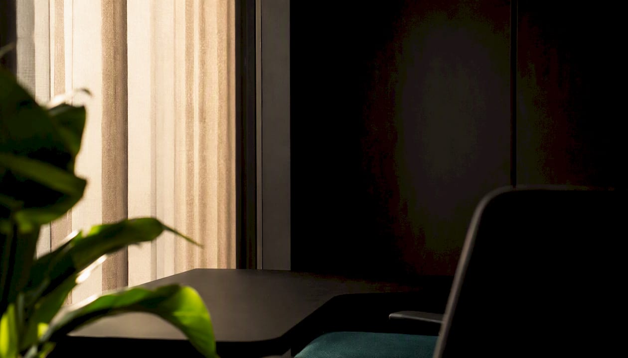 Quiet minimalist office corner with soft light