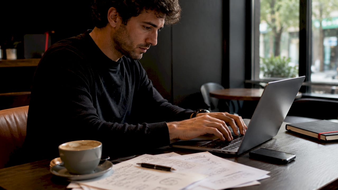 Usare LinkedIn per generare lead: guida startup 2026 2 Mani che digitano sulla tastiera per aggiornare e ottimizzare il profilo LinkedIn