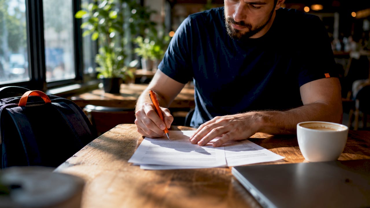 Developer signing NDA document at co-working space