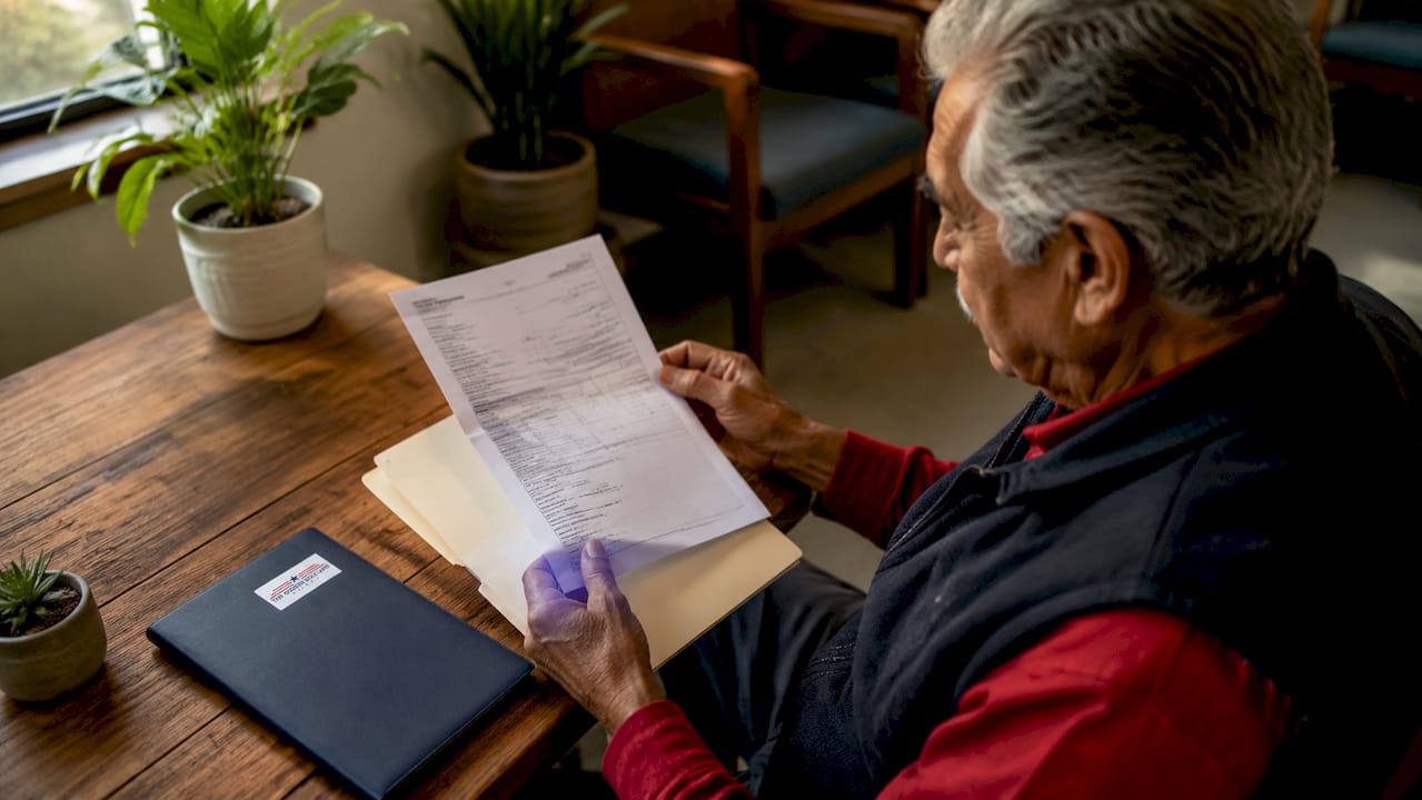 Hands holding eye exam medical bills and records