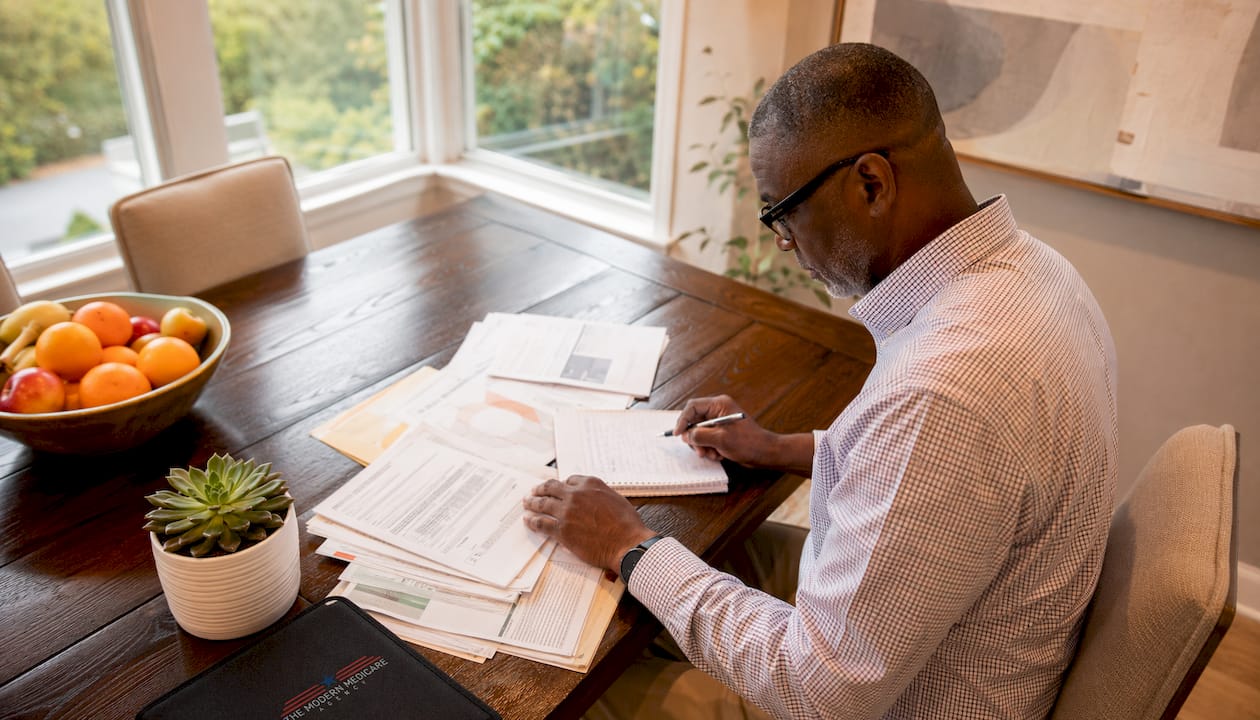 Man managing hospital indemnity insurance paperwork