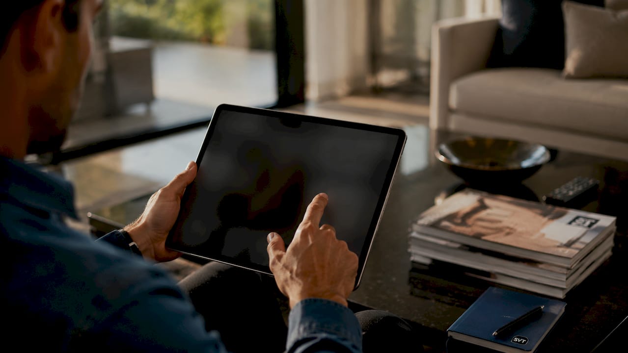 Close-up hands navigating virtual tour on tablet