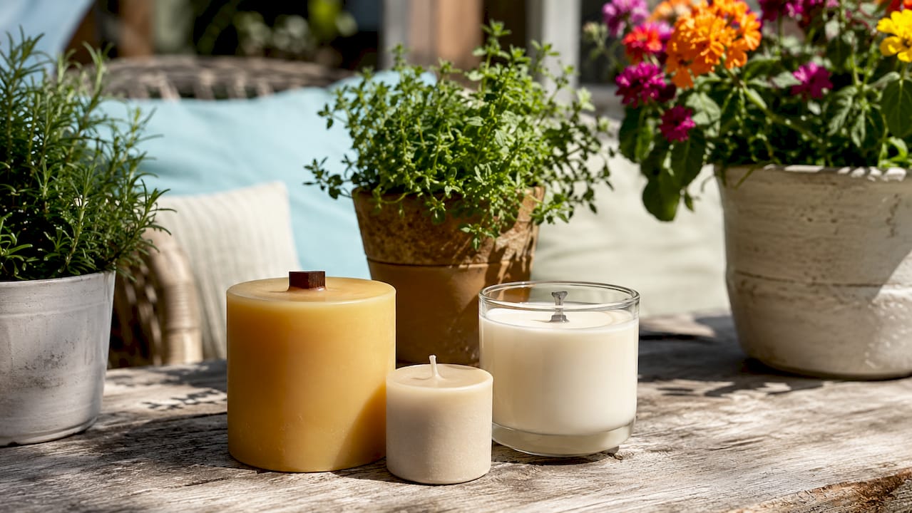Various candle types and wick styles on kitchen shelf