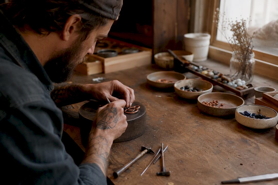 Hands crafting unique silver jewelry