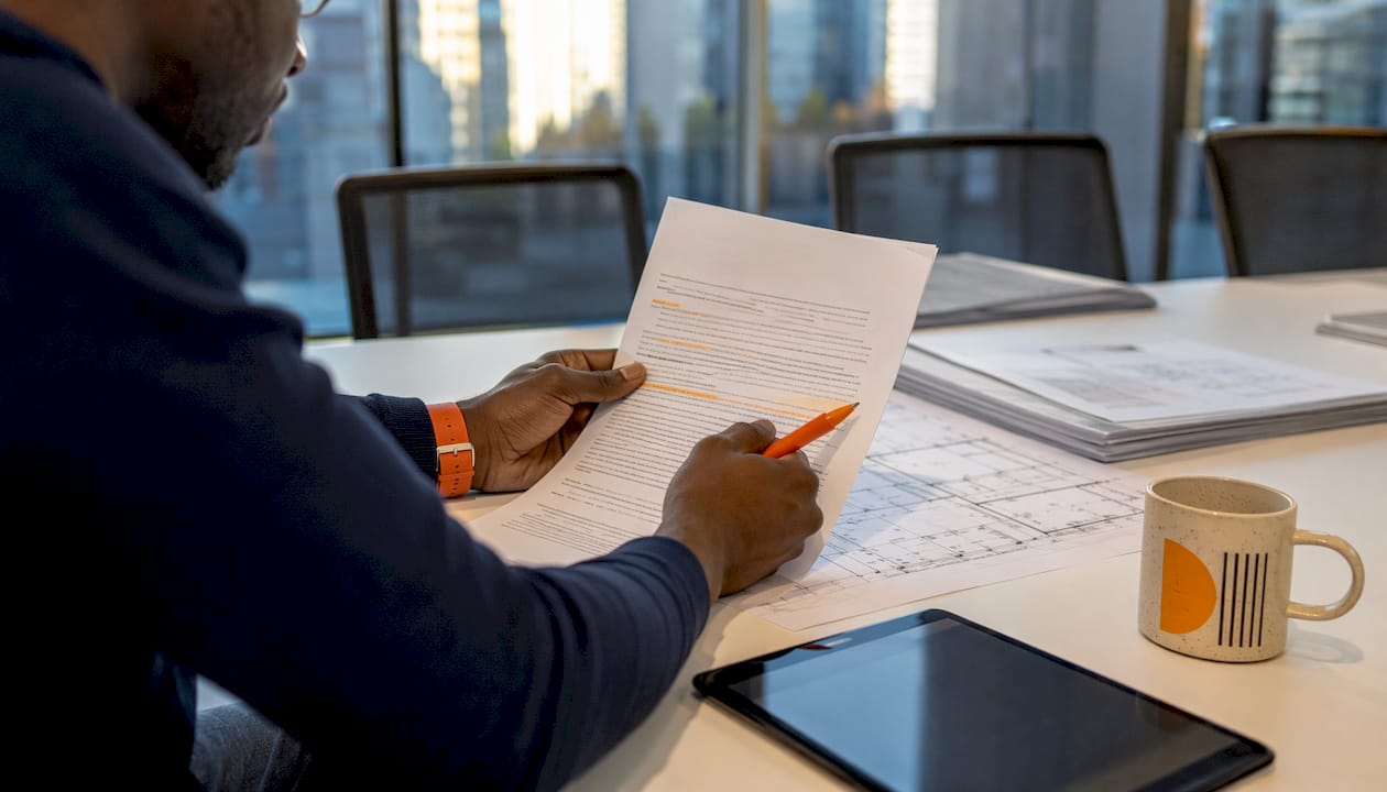 Hands pointing at construction ITB document details