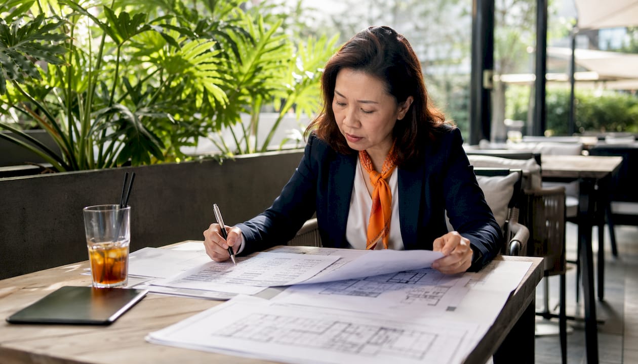 Project manager reviewing integrated cost estimate documents