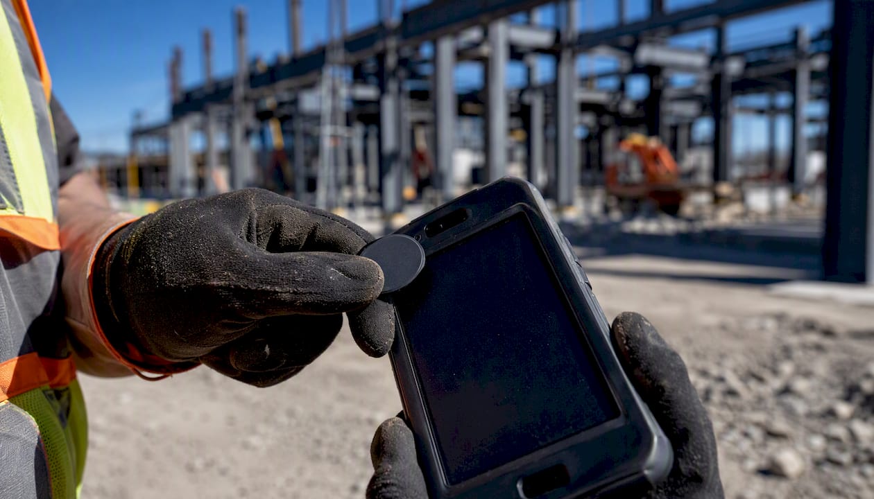 Foreman tapping NFC token on rugged device