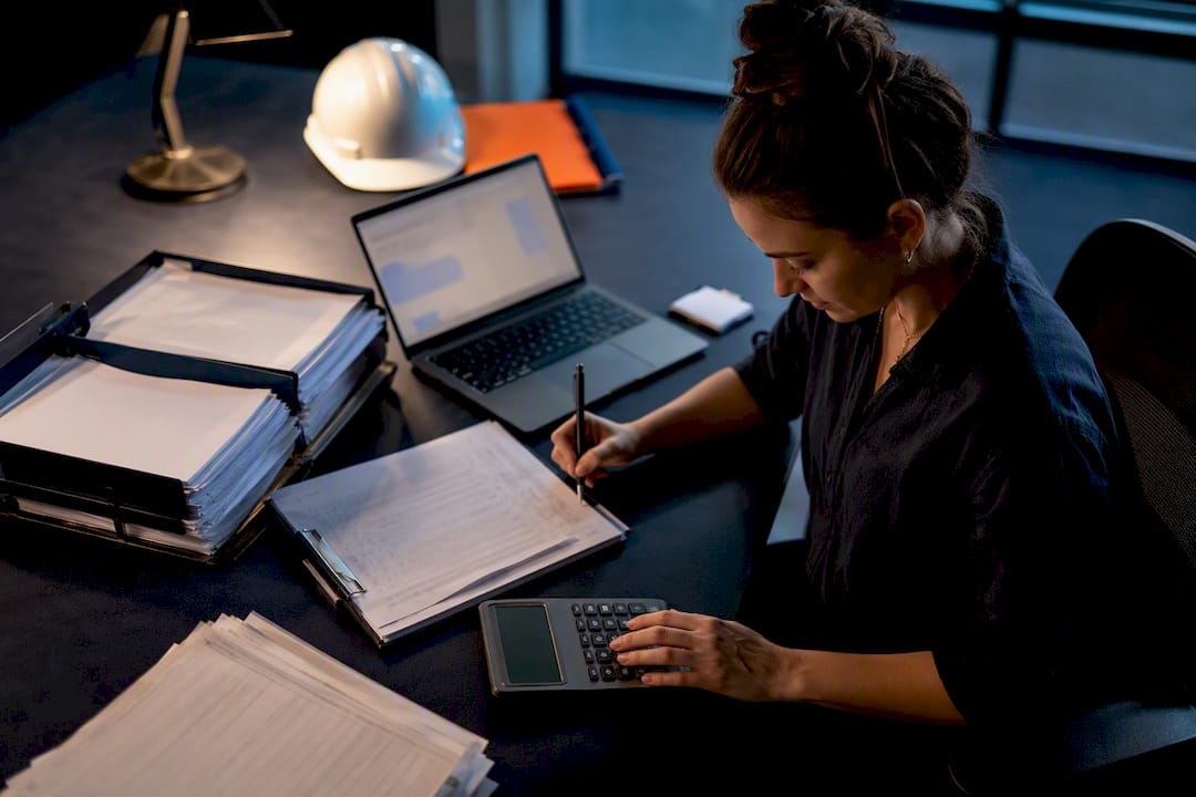 Payroll coordinator reconciling construction time records
