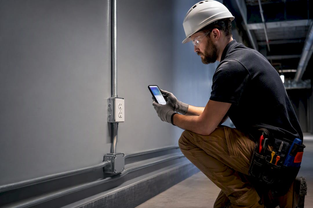 Electrician documenting added construction work
