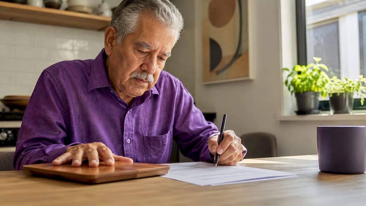 Hands reviewing bank regulation documents at desk