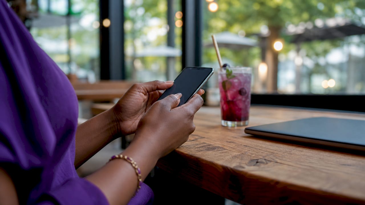 Hands entering authentication code on smartphone