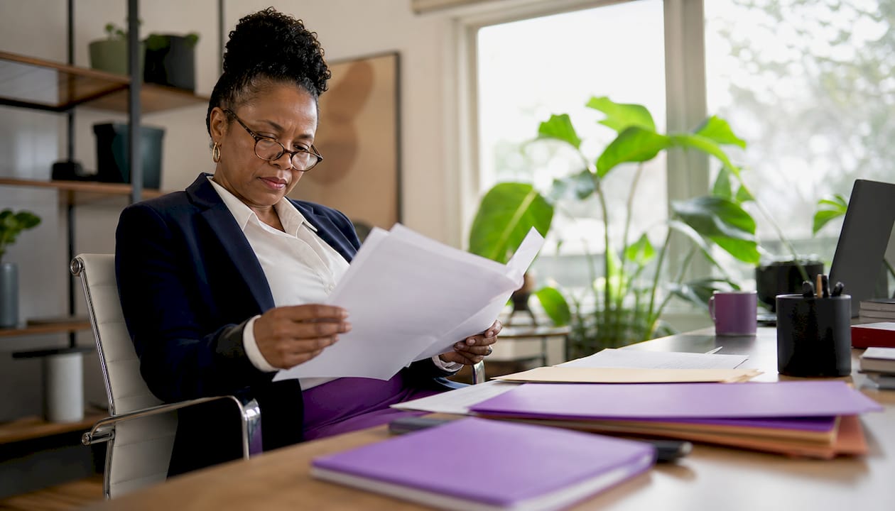 Compliance officer reviewing brokerage payment paperwork
