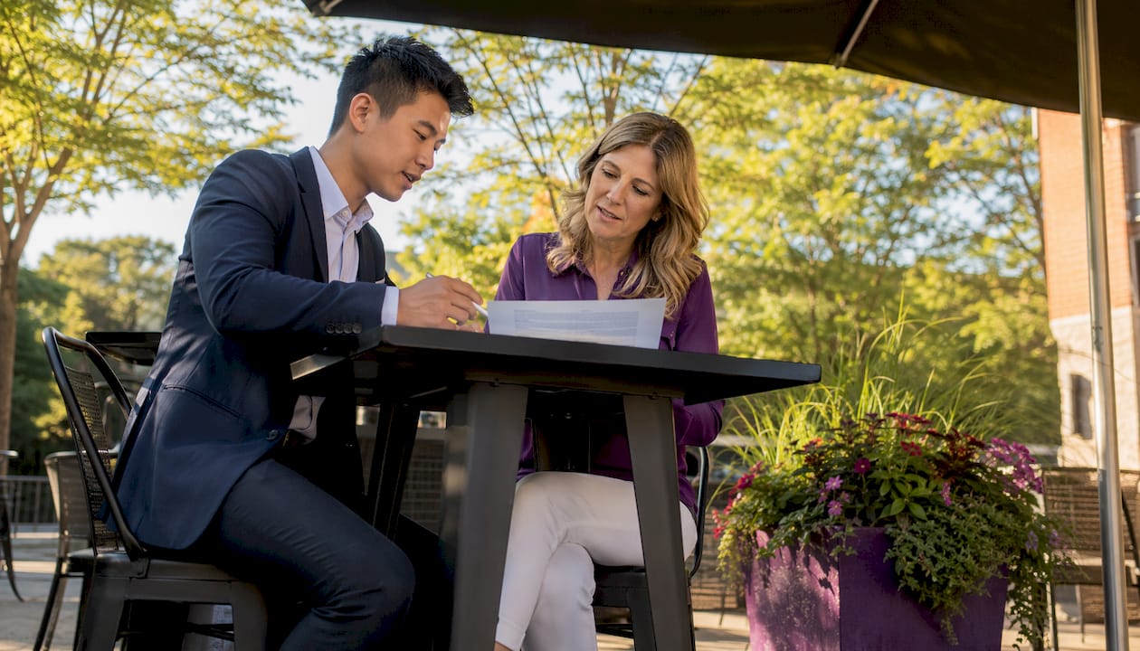 Agent and client reviewing commission fees
