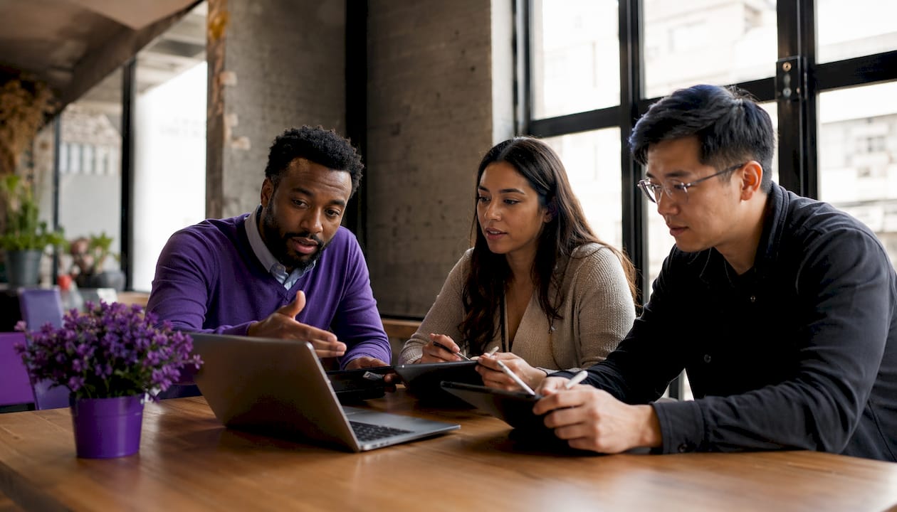 Team discussing brokerage software options