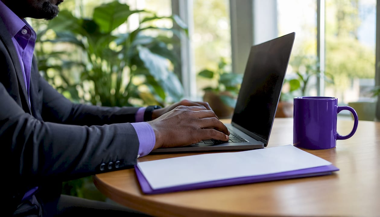 Broker managing referral payment on computer