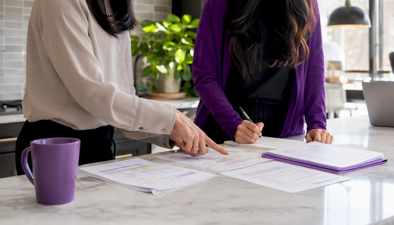 Hands organizing payment compliance controls documents