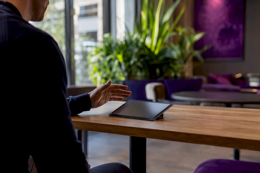 Hand poised to sign on digital signature pad