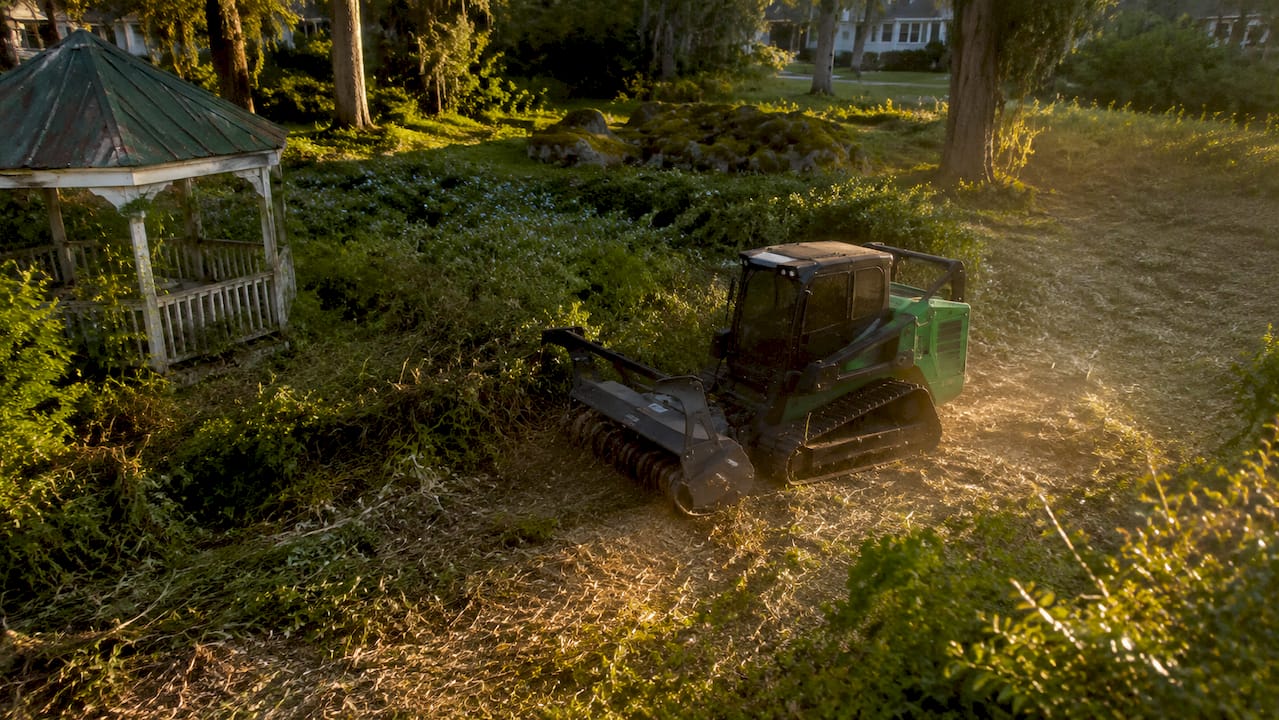 Forestry mulching machine clearing backyard brush