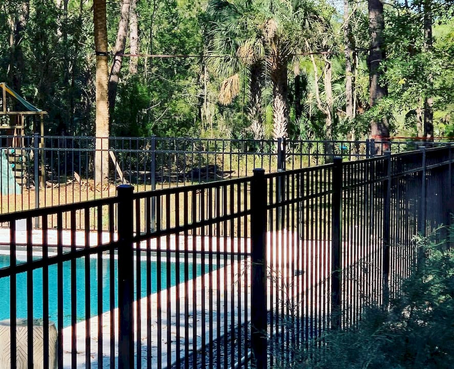 Pool fence material samples on outdoor workbench