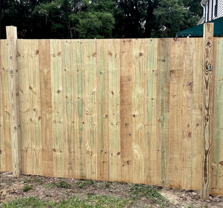 Installer adding anti-climb topper to metal fence