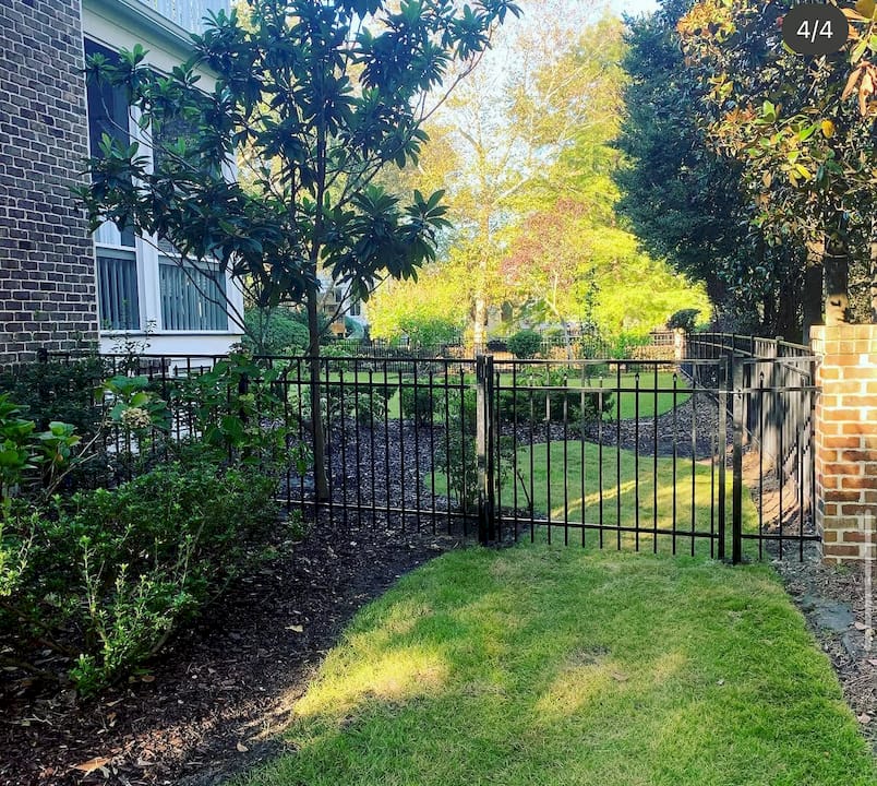 Homebuyer examining aluminum fence detail