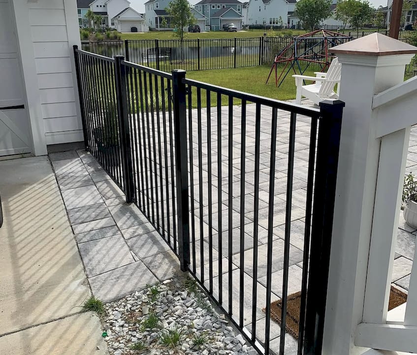 Technician inspecting powder-coated aluminum fence panel
