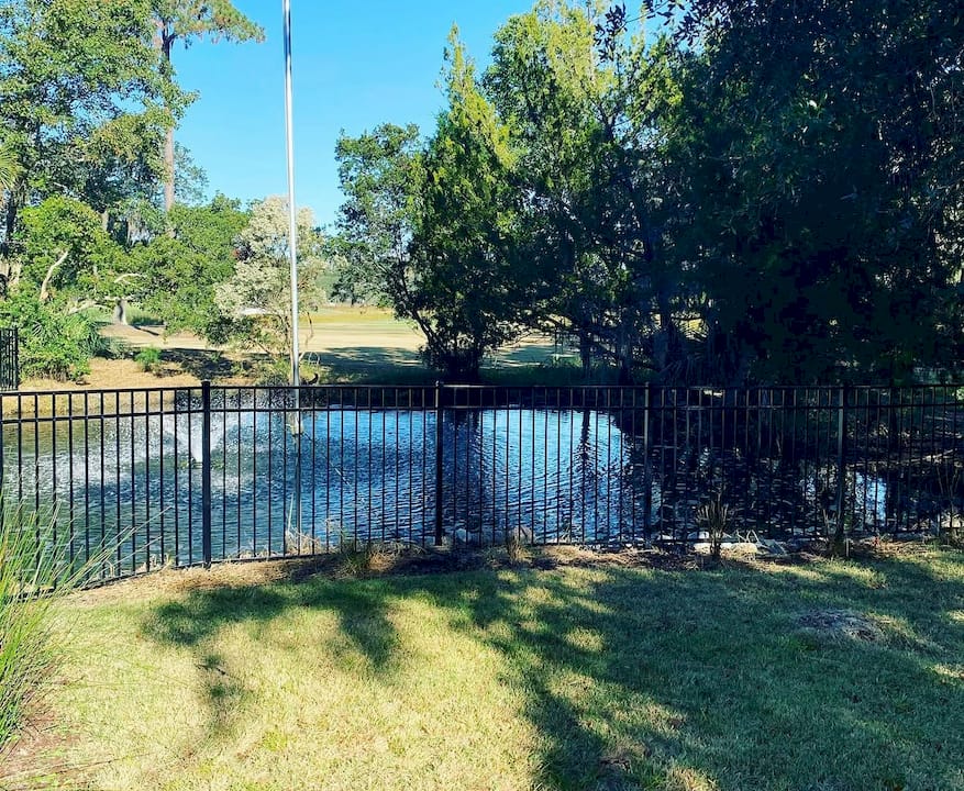 Hands tightening aluminum fence post outdoors