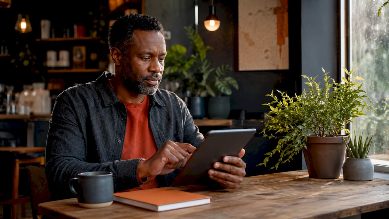 Man interacting with meditation app onboarding on tablet