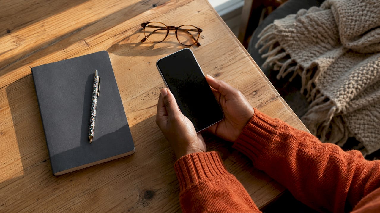 Hands holding smartphone for meditation intake app