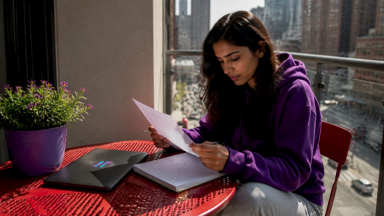 Woman reviewing beginner trading plan at desk