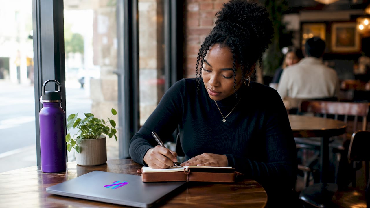 Woman writing detailed trading journal notes