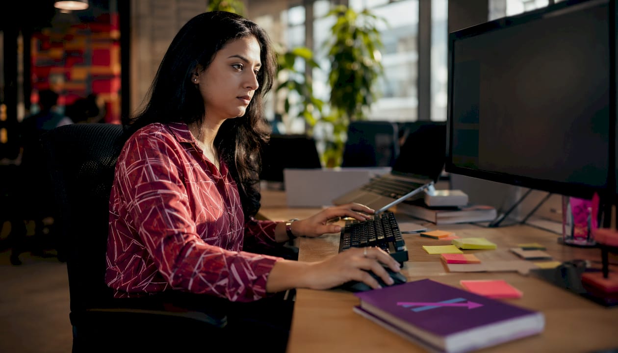 Hands adjusting trading indicators at computer