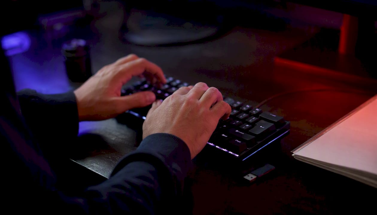 Hands typing webhook URL on keyboard