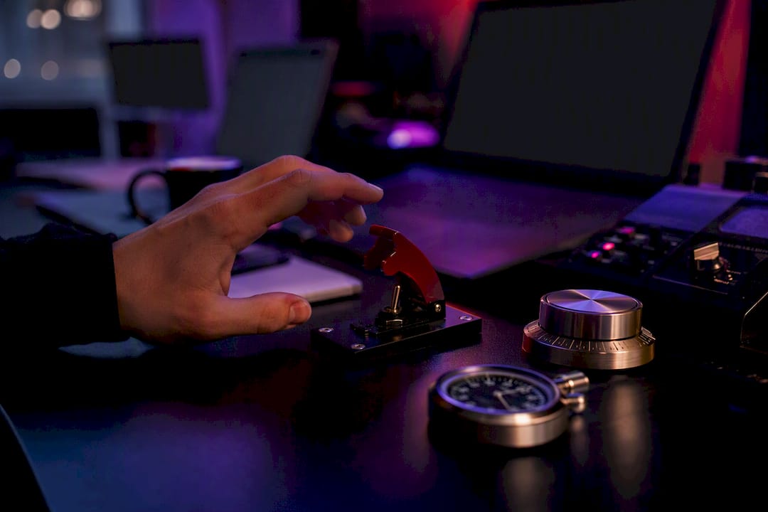 Hand reaching manual override switch on trading desk