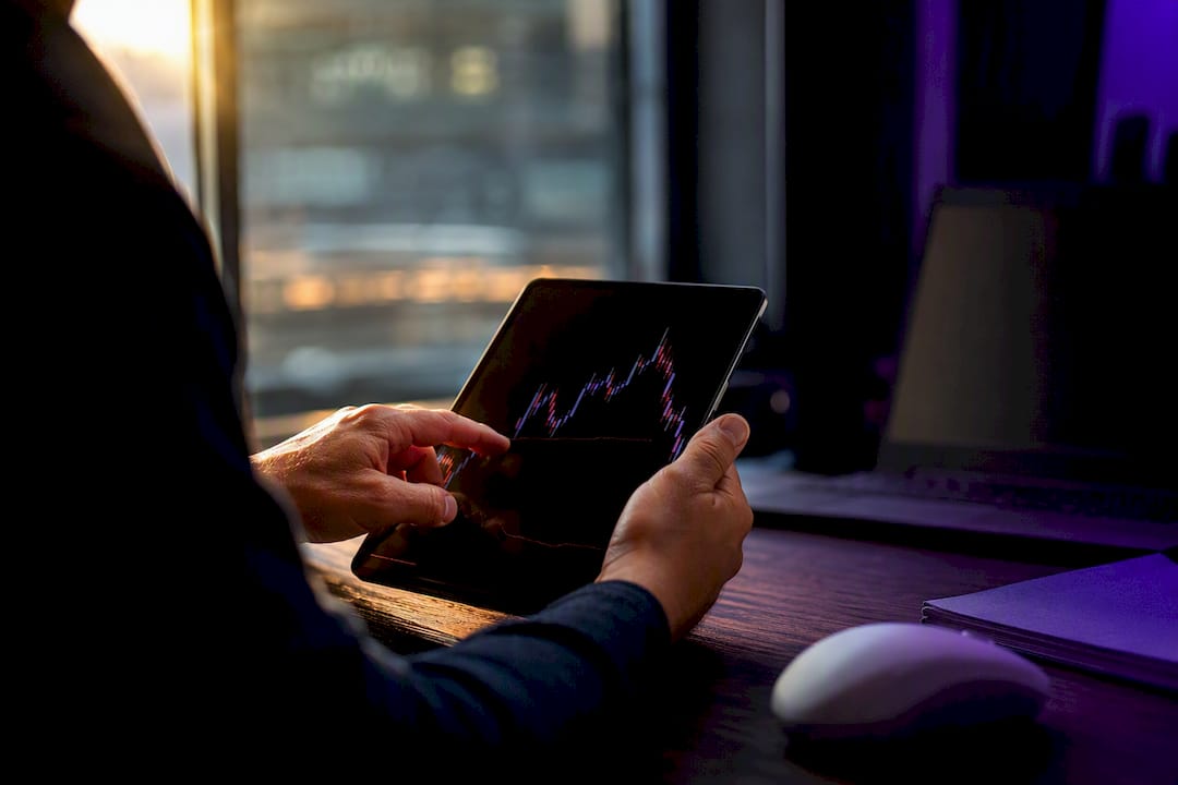 Trader hands holding tablet with dark screen