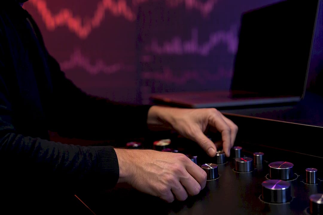 Hands adjusting trading algorithm dials